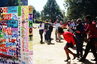 The university community pulled down the wall Friday.
